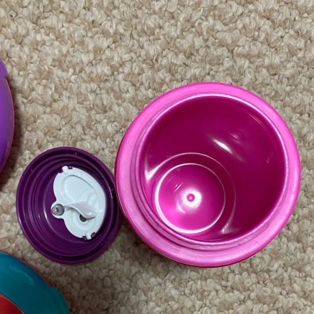 2 bibs, green & blue, 2 suction bowls, pink & purple, 1 tommie tippie sippie cup